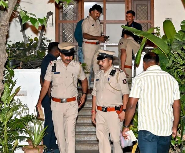 Police officials searching Rohan Saldanha