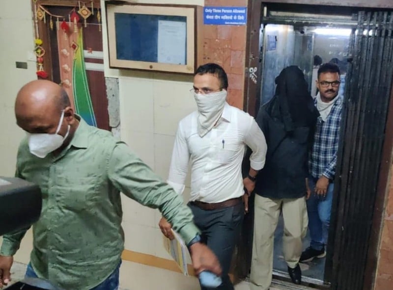 Police taking Manoj Sane (in black face cover) for the court hearing