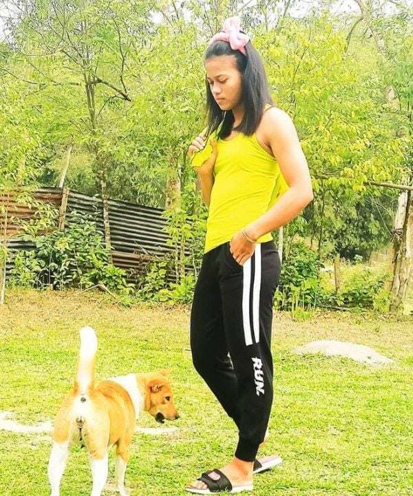 Popy Hazarika playing with her dog