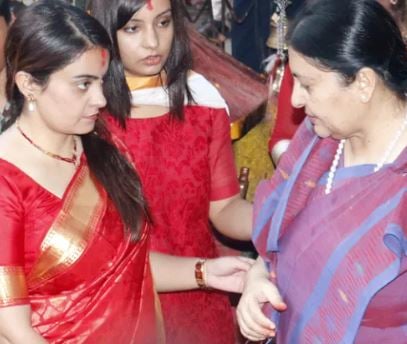 President Bidya Devi Bhandari talks to her daughters as she returns from a temple in Kathmandu Valley, on the day of Maha Ashtami in 2016