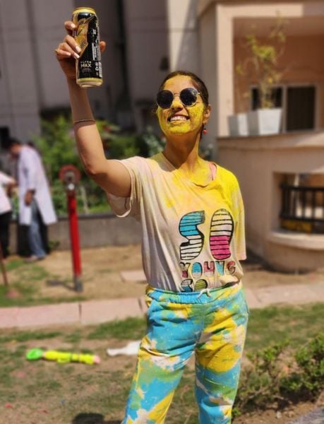 Priya Chauhan posing with her can of beer on the festival of Holi