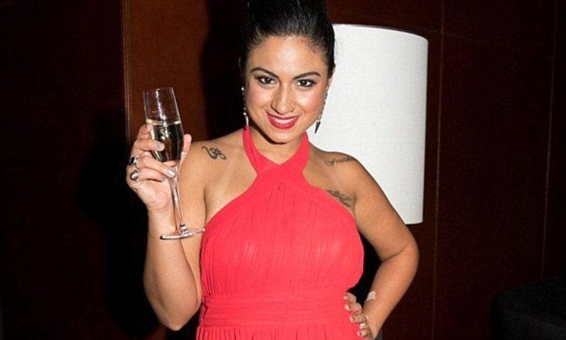 Priya Malik holding a glass of champagne