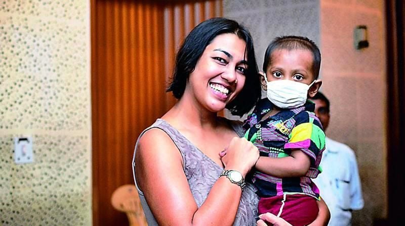 Purnota Dutta Bahl with a Child of Cuddles Foundation