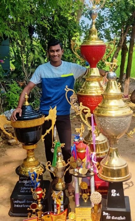 R Guhan posing with his district and national level trophies and prizes