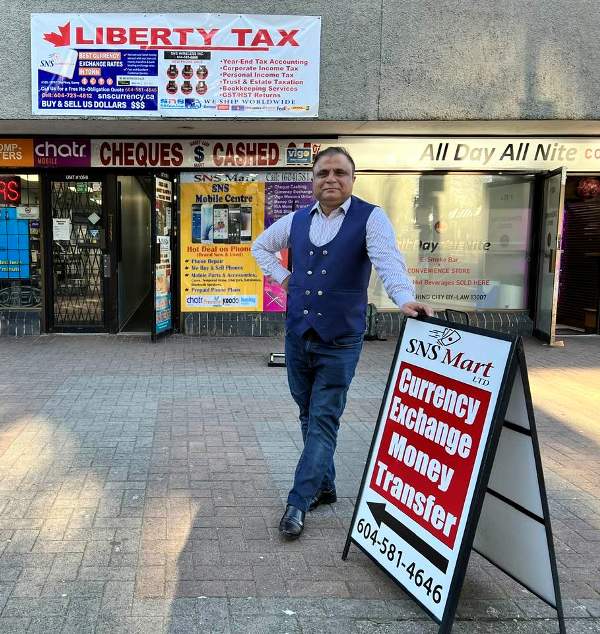 Rahat Rao while posing outside his SNS Currency Exchange located near Surrey Central Station in Canada