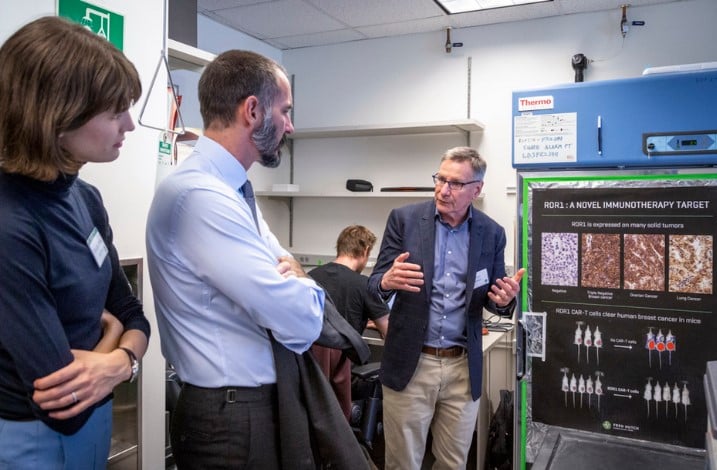 Rahim Al-Hussaini while discussing research at the laboratory of Dr. Stanley Riddell during his tour of Fred Hutchinson Cancer Research Center