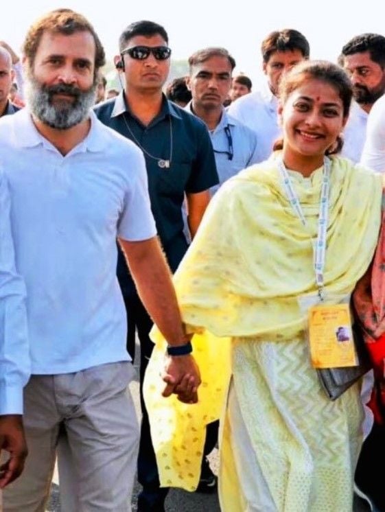Rahul and Praniti holding hands during the march