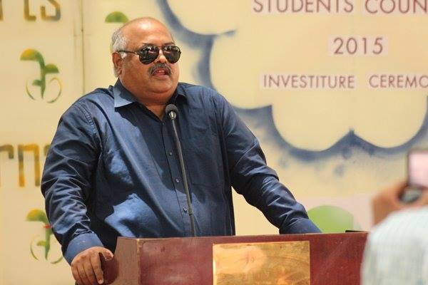 Rajesh Das speaking at a charity program