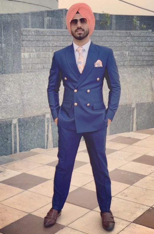 Ramandeep Singh wearing a turban and suit