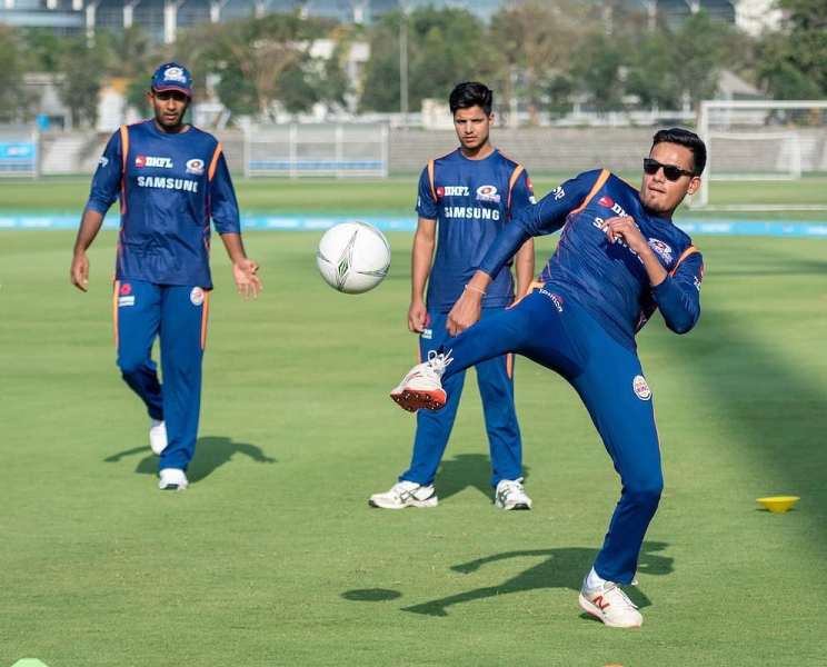 Rasikh Salam playing football with his teammates