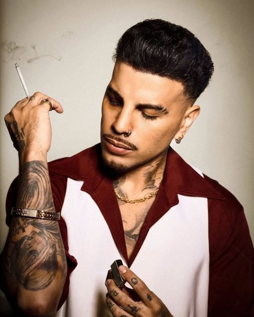 Rauw Alejandro holding a cigarette