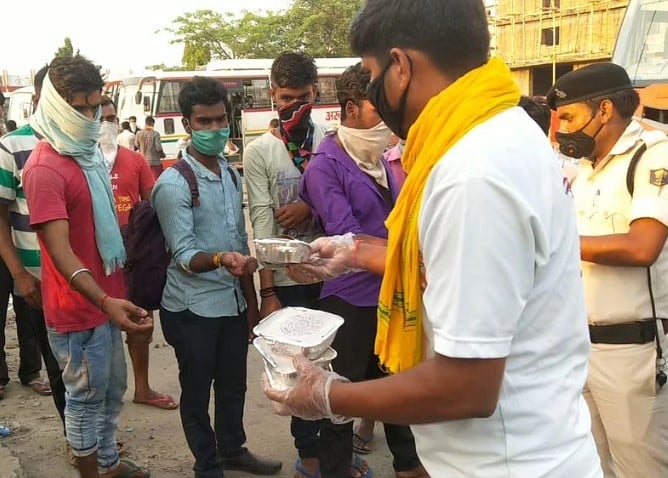 Ravi Shankar while distributing food to the migrant workers at Chhapra Railway station duing the COVID-19