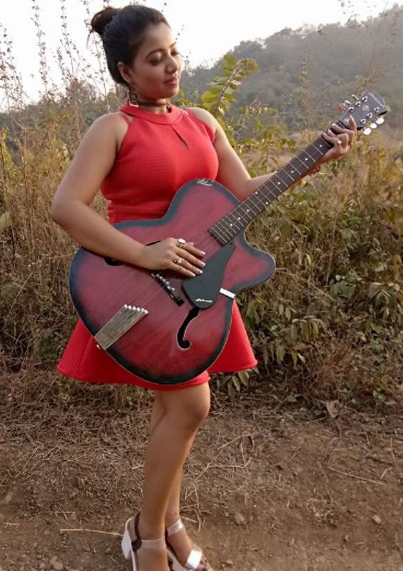 Rekha Mona Sarkar playing the guitar