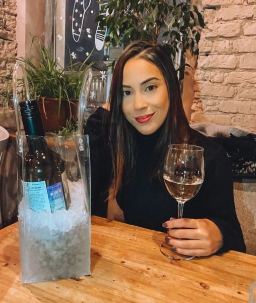 Renata Saldanha drinking wine in a restaurant in Russia