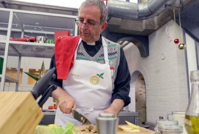 Reverend Richard Coles cooking in the Celebrity Masterchef Kitchen
