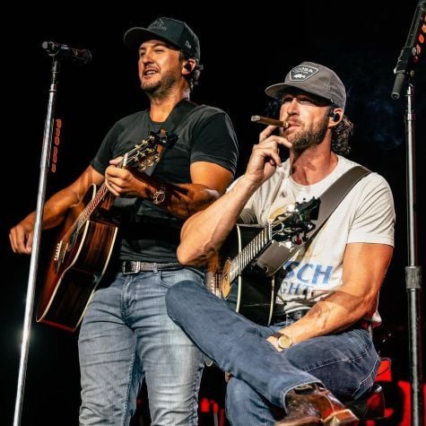 Riley Green smoking a cigar on stage