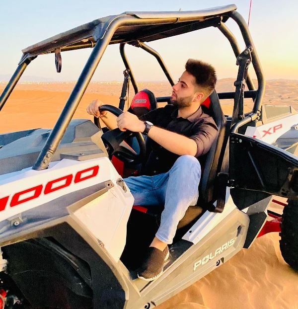 Rishi Athwani in Dubai desert posing with buggy ride