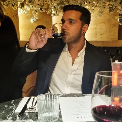 Rishi Nair consuming wine
