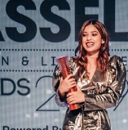 Riya Jain receiving an award