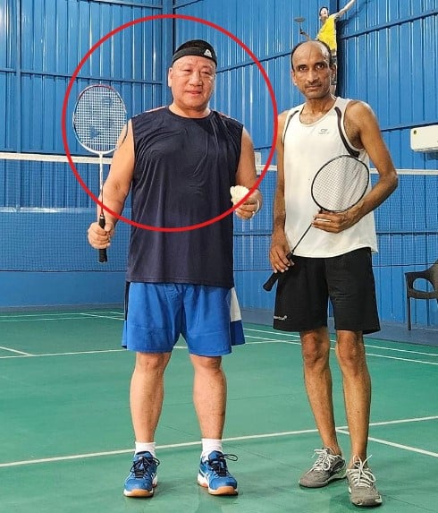 Robin Hibu posing at a badminton court