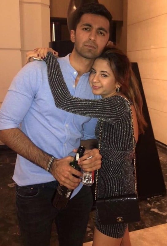 Rohan Gurbaxani (left) drinking an alcoholic beverage during a party