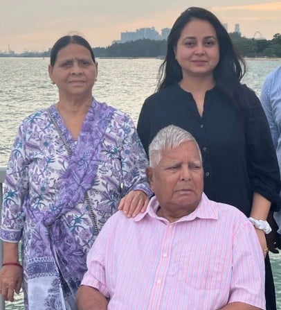 Rohini Acharya posing with her parents