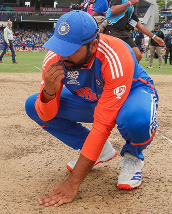 Rohit Sharma eating a few strands of grass from the pitch in Barbados after the T20 World Cup win on 29 June 2024