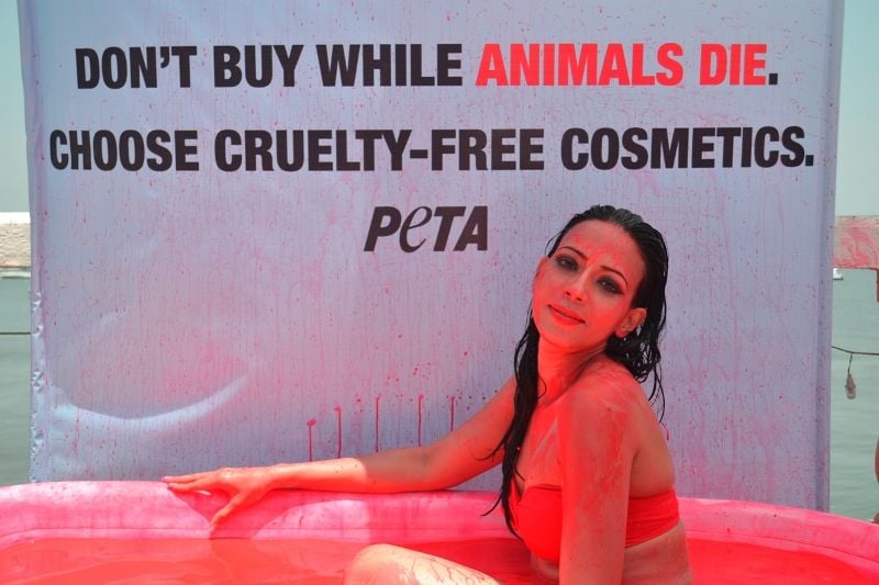 Rozlyn Khan bathing in blood-red coloured water during a photoshoot for PETA campaign