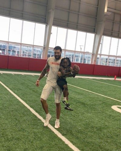 Rudolph Ingram playing football with professional American footballer Mike Evans