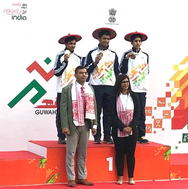 Rudrankksh Patil (center) after winning a gold medal at 10m air rifle men