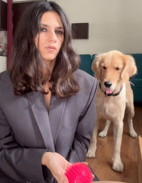 Runjhun Sharma posing with her pet dog