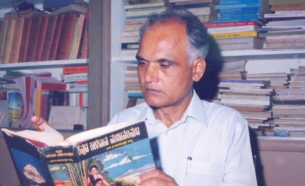 An old picture of S. L. Bhyrappa while reading a book in a library