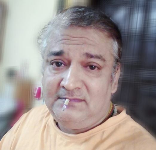 Saibal Bhattacharya while smoking a cigarette