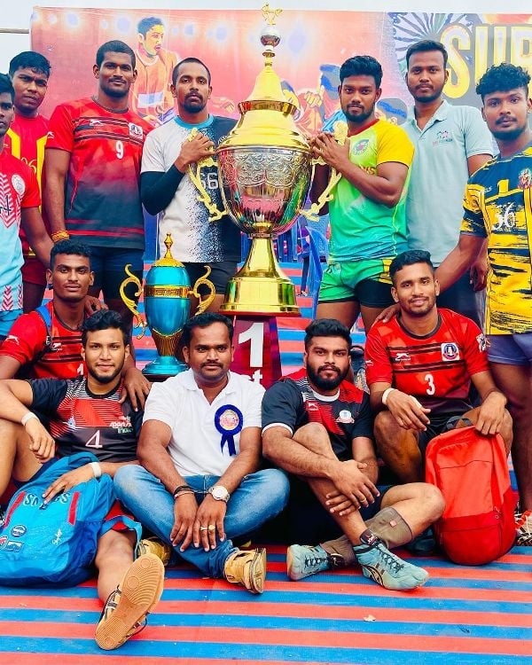 Sajin Chandrasekar (standing right to the trophy) posing with his team at the All India Tournament in Krishnagiri, Tamil Nadu