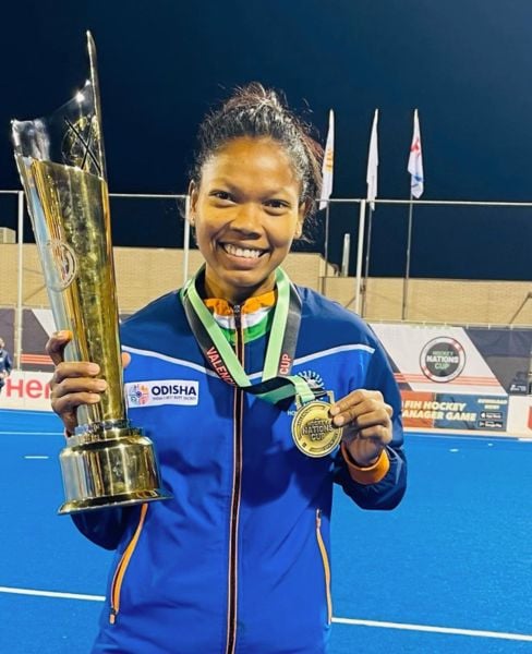 Salima Tete posing with the winning trophy of the Women’s FIH Hockey Nations Cup in Valencia, Spain (2022)