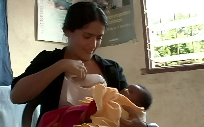 Salma Hayek breastfeeding a newborn during her visit to Sierra Leone with UNICEF in September 2008