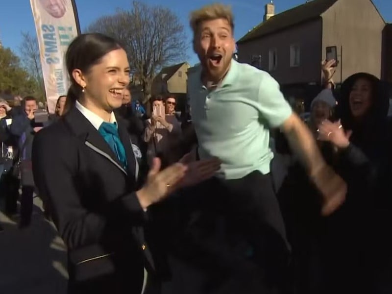 Sam Thompson celebrating after setting the Guinness World Record for most hugs