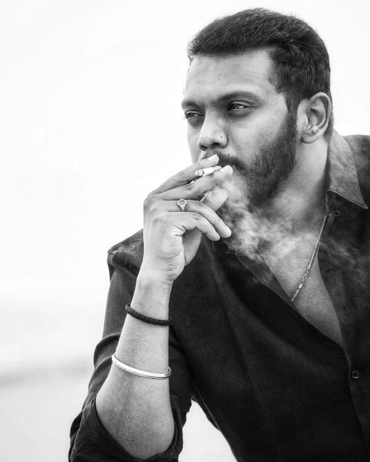 Sandeep Raj smoking a cigarette