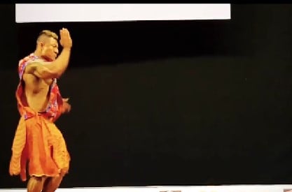 Sangay Tsheltrim while performing martial arts on a stage