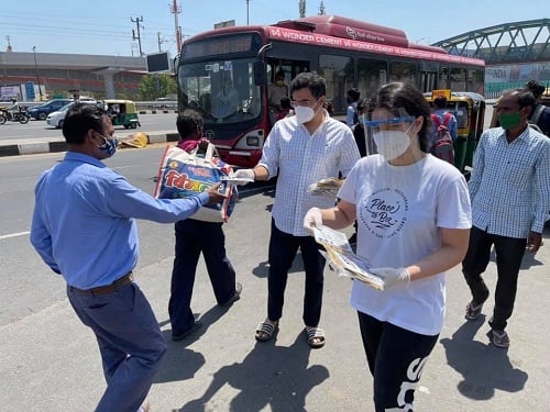 Sanidhi Singh distributing mask with her father