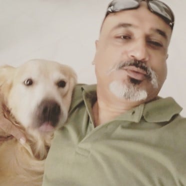 Sanjay Nath posing with his pet dog