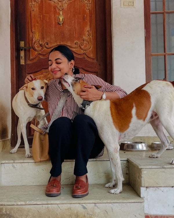 Santhy Balachandran posing with her dogs