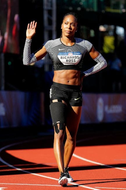 Sanya Richards-Ross wearing her compression sleeves and acknowledging the crowd supporting her