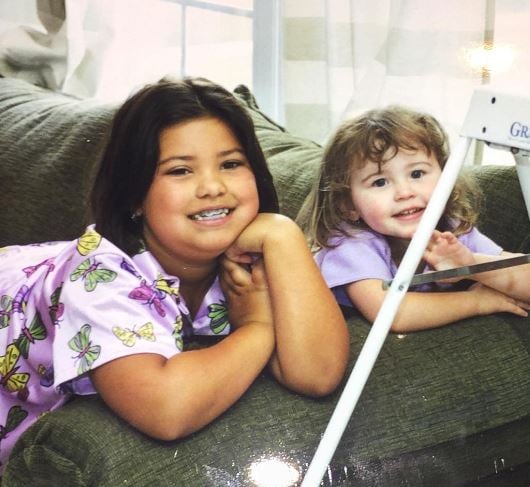 Sarah Carpenter (right) in childhood with her half-sister Cayla Carpenter