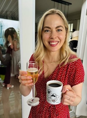 Sarah Dugdale holding a glass of alcohol