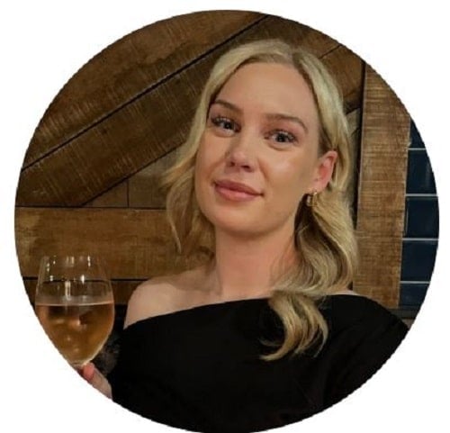 Sarah Griffiths holding a glass of wine