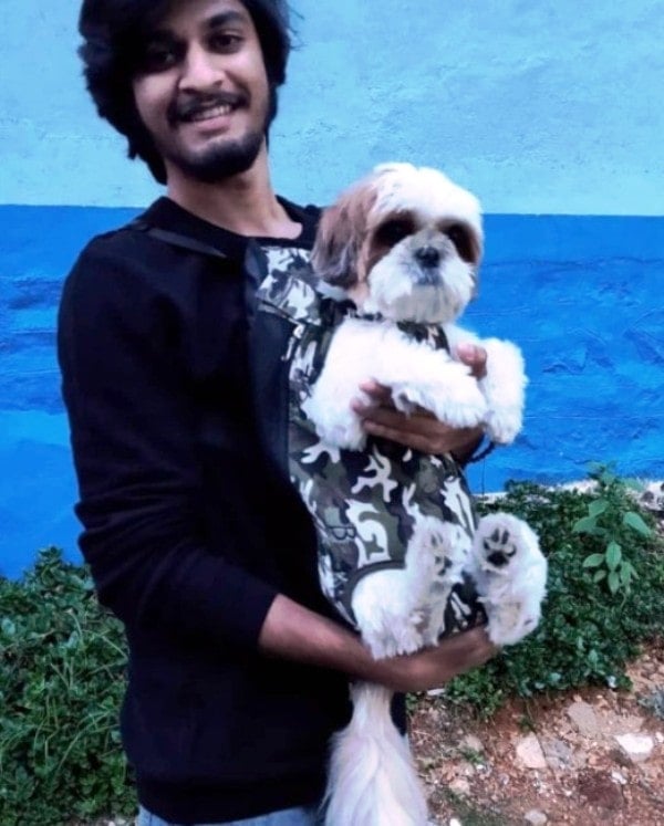Saran with his pet dog Peeku