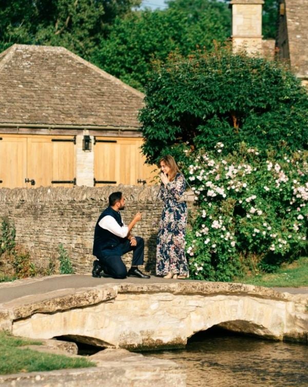 Saransh Goila, while proposing to Divya Rao on a stone bridge in Lower Slaughter, Cotswolds, England