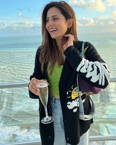 Sargun Mehta holding a glass of wine