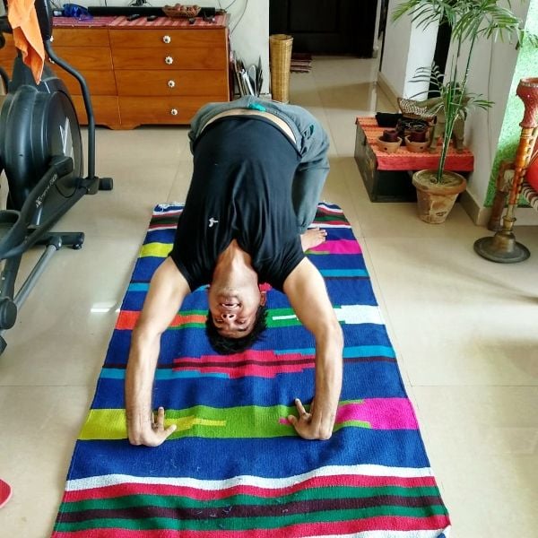 Saurabh Dwivedi performing wheel pose